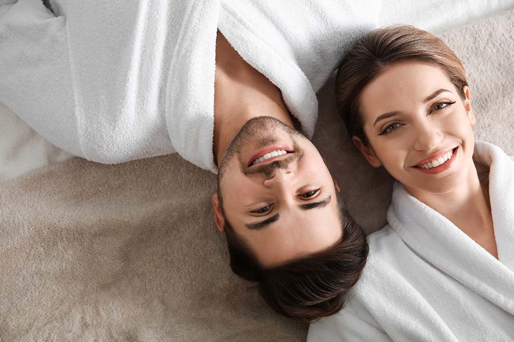 Couple comfortable in white housecoats awaiting a treatment.  PEMF Therapy. Dr. Steenblock services.